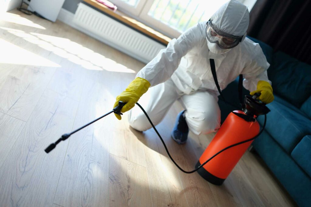 Pest control technician working inside a home.